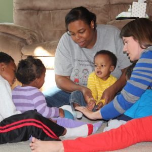 educator with family in home